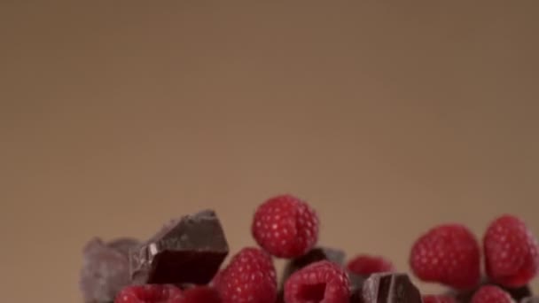 Raspberries Chocolate Flying Brown Background Slow Motion Shot Phantom Flex — Stock Video