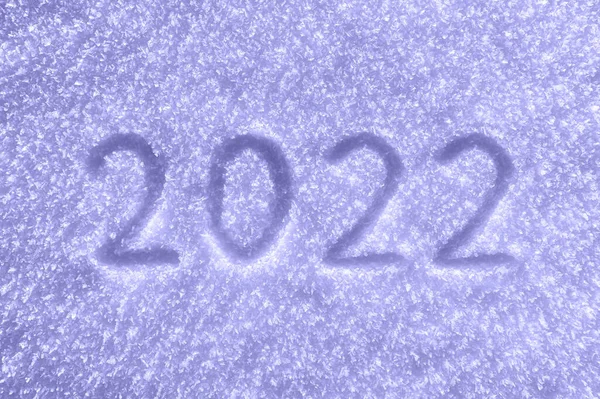 Snow texture. Čísla 2022 napsaná na zasněženém povrchu, tónovaná v trendy Very Peri. Barva roku 2022. — Stock fotografie