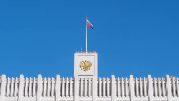 青い空に手を振る旗を持つロシアの白い家の建物 — ストック動画