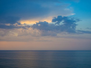 Bulutlu gökyüzü ve dalgalı deniz manzarası