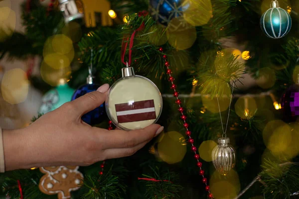 Close Girls Hand Holding Christmas Ball Fir Tree Flag Latvia — Photo