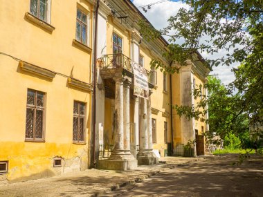 Sambir, Ukraine - May, 2022: Historical and ethnographic museum Boikivshchyna in ukrainian on poster in Sambor. Old beautiful building with columns in the park. Architecture in Lviv region.