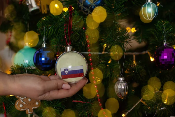 Close Girls Hand Holding Christmas Ball Fir Tree Flag Slovenia — Stockfoto