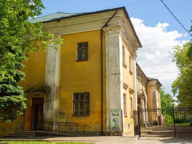 Sambir, Ukraine - May, 2022: Historical and ethnographic museum Boikivshchyna in ukrainian on poster in Sambor. Old beautiful building with columns in the park. Architecture in Lviv region.