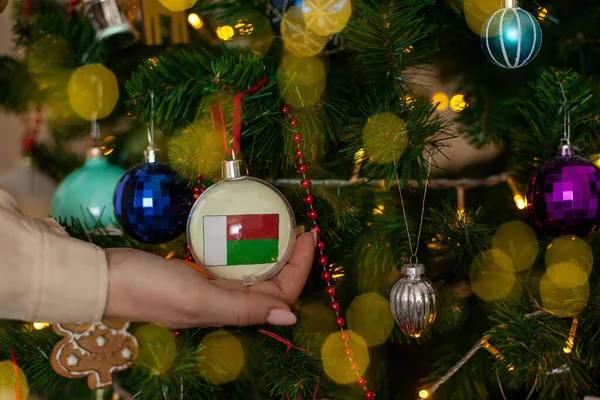 Close Girls Hand Holding Christmas Ball Fir Tree Flag Madagascar — Fotografia de Stock