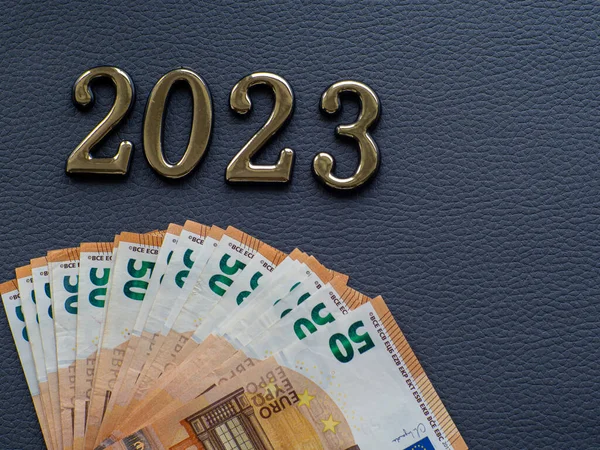 Set of European Union money with a face value of 50 euros. Background of the fifty euros banknotes and 2023 with copy space. Enterprise capital investment, finance, savings, bank and New Year concept