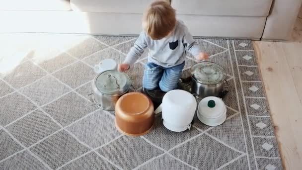 Child drummer having fun drum playing on kitchen pans at home — Stock Video