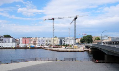 Berlin, Germany, July 13, 2022, view at the Elsenbrucke over the river Spree to the buildings and a construction site at Stralauer Allee