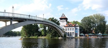 Berlin, Germany, July 29, 2022, curved abbey bridge over the Spree River at the Island of Youth.