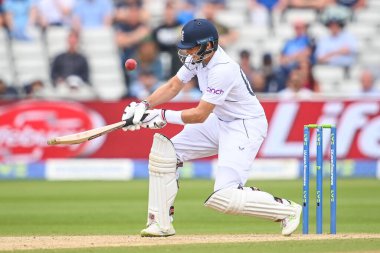 Joe Root of England plays a scoop shot for a six (6)