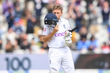 Joe Root of England celebrates a century (100 runs) and kisses the England badge on his helmet clipart