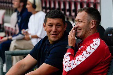 Danny McGuire Head Coach of Hull KR chats with Matt Peet Head Coach of Wigan Warriors before the game 
