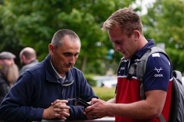 Jez Litten #14 of Hull KR chats with a fan before the game 