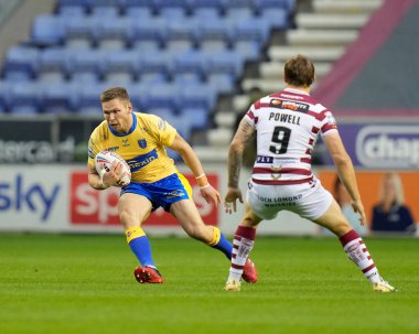 Matt Parcell #9 of Hull KR side steps Sam Powell #9 of Wigan Warriors 