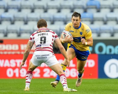 Sam Wood #24 of Hull KR runs at Sam Powell #9 of Wigan Warriors 