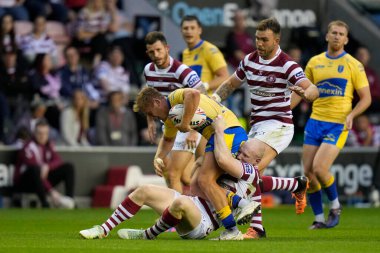 Liam Farrell #12 of Wigan Warriors tackles Jez Litten #14 of Hull KR