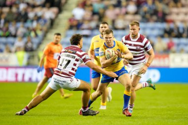 Matt Parcell #9 of Hull KR runs at Oliver Partington #17 of Wigan Warriors