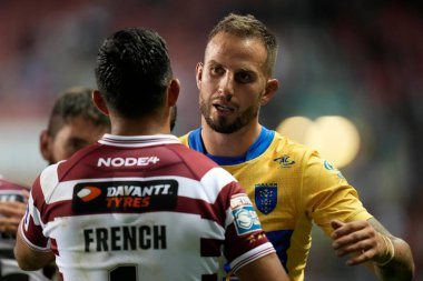 Ben Crooks #2 of Hull KR greets Bevan French #1 of Wigan Warriors after the match