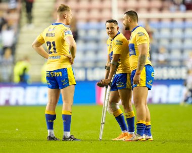 Charlie Cavanaugh #30 of Hull KR is consoled by  Elliot Minchella and  Rowan Milnes after the match as he walks with crutches to greet the fans 