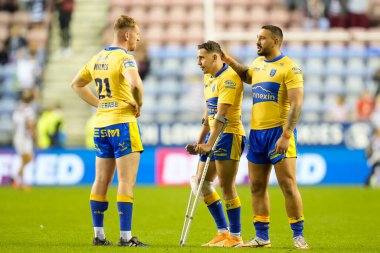 Charlie Cavanaugh #30 of Hull KR is consoled by  Elliot Minchella and  Rowan Milnes after the match as he walks with crutches to greet the fans 