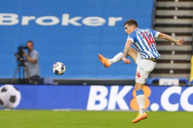 Josh Ruffels #14 of Huddersfield Town makes a clearance 
