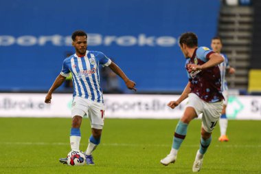 Duane Holmes #19 of Huddersfield Town passes the ball 