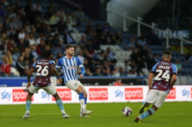 Oliver Turton #2 of Huddersfield Town passes the ball