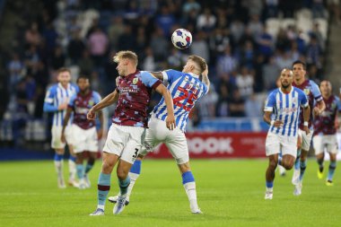 Danny Ward #25 of Huddersfield Town and Charlie Taylor #3 of Burnley challenge for a header 