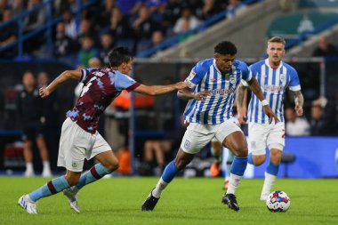 Tina Anjorin #8 of Huddersfield Town runs at the Burnley defence
