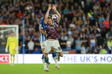 Tom Lees #32 of Huddersfield Town and Ashley Barnes #10 of Burnley challenge for the ball 