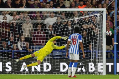 Lee Nicholls #21 of Huddersfield Town dives as the ball hits the post 
