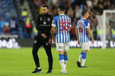 Yuta Nakayama #33 of Huddersfield Town and Danny Schofield at the final whistle 