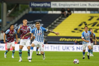 Danny Ward #25 of Huddersfield Town shrugs off a challenge from Taylor Hardwood-Bellis #5 of Burnley 