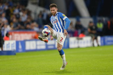Oliver Turton #2 of Huddersfield Town passes the ball