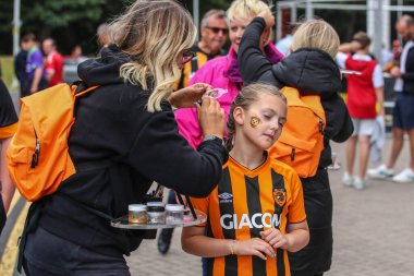 A young Hull City fan has her face paint applied