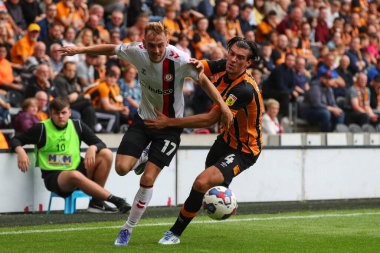 Mark Sykes #17 of Bristol City and Jacob Greaves #4 of Hull City challenge for the ball