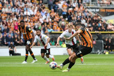 Ozan Tufan #7 of Hull City scores a penalty to make it 1-1