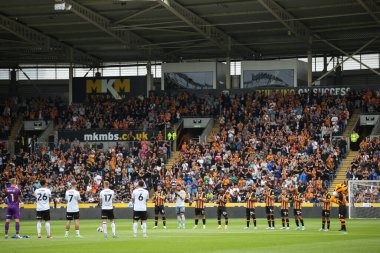 Players observe a minutes applause for the passing of Terry Neil 