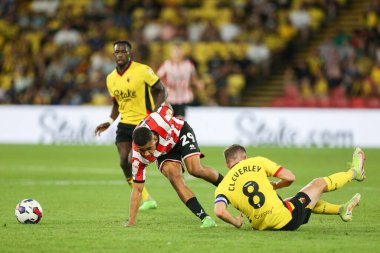 Iliman Ndiaye #29 of Sheffield United evades a tackle fro, Tom Cleverley #8 of Watford 
