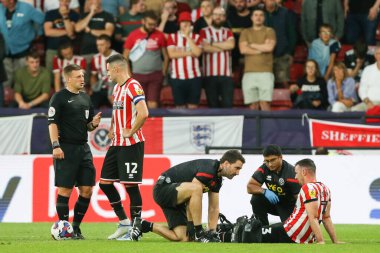 Enda Stevens #3 of Sheffield United receives treatment for a knock