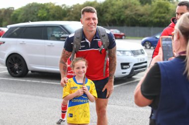 A young fan has her photo taken with Shaun Kenny-Dowall #4 of Hull KR 