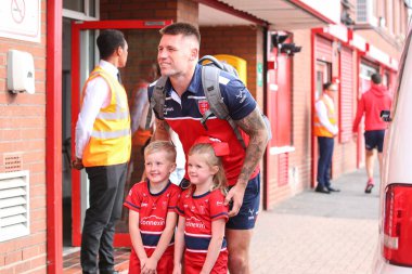 Two young fans have their photo taken with Shaun Kenny-Dowall #4 of Hull KR 
