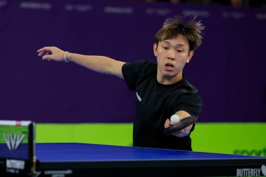 Shen Wong Qi of Malaysia stretches for the ball in the game against Sanil Shetty and Reeth Tennison of India