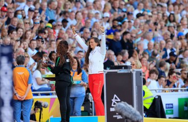 Jade Lally of England receives her silver medal for the women's discus