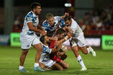 Matt Parcell #9 of Hull KR is tackled by 4 Toulouse defence players