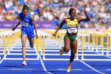 Megan Tapper of Jamaica on her way to winning the heat of the womens 100m hurdles 