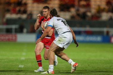 Rowan Milnes #21 of Hull KR runs at Joe Bretherton #16 of Toulouse Olympique 