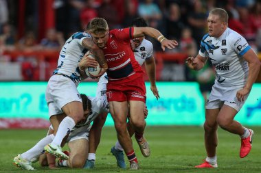 Jimmy Keinhorst #18 of Hull KR is stopped by the Toulouse defence 