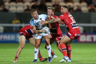 Matty Russell #25 of Toulouse Olympique is stopped by the Hull KR defence