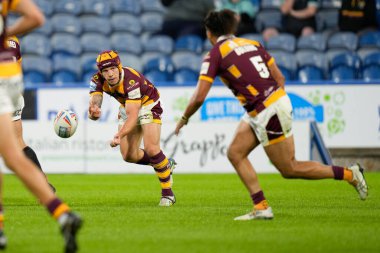 Theo Fages #7 of Huddersfield Giants passes the ball